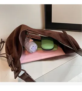 Top view of spacious interior in a brown suede hobo bag showing large storage capacity