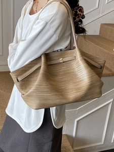 Retro khaki woven tote bag with adjustable leather strap and elegant gold buckle