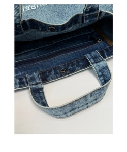 Détails du sac en denim montrant la fermeture magnétique et la poche zippée interne