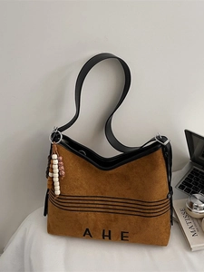 Brown faux suede tote bag with black leather straps and boho bead charm accessory