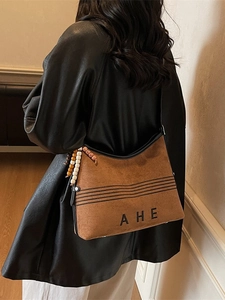 Vintage brown suede tote bag with black AHE letter print and colorful beaded tassel detail