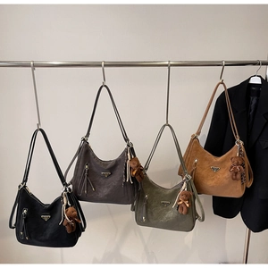 Detail view of retro soft leather shoulder bags in four colors with bear charms