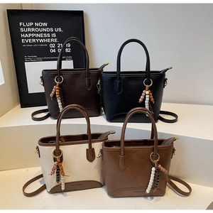 Detailed display of four vintage bucket bags in various colors with beaded charms