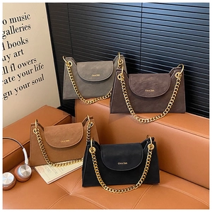Detail view of four textured chain flap bags in grey, chocolate, tan, and black colors