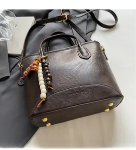 Macro shot of dark brown vintage leather bag base with golden anti-wear studs