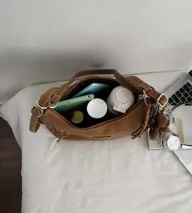 Interior view of brown vintage tote bag showing large capacity with personal essentials