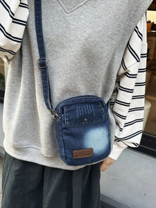 Vintage blue denim crossbody phone bag for travel with adjustable strap and leather patch