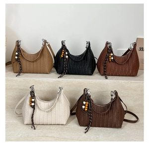 Five pleated moon bags in tan, black, and cream colors with decorative wooden beads