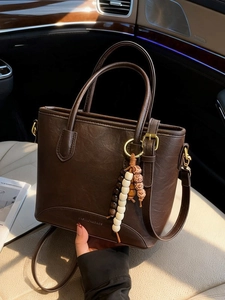Vintage dark brown textured leather bucket bag with top handle and wooden bead charm