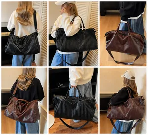 Detailed view of woven leather texture and large capacity structure on the travel bag