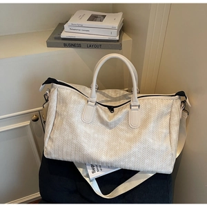 Close-up of the elegant V-shaped woven texture on this white large capacity travel tote bag