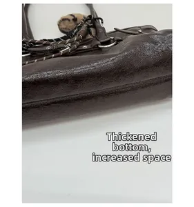 Detailed macro view of the reinforced thick bottom and spacious base of the coffee leather bag
