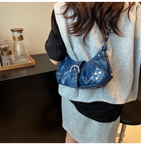 Detail view of blue crocodile pattern Y2K shoulder bag with silver rivet hardware
