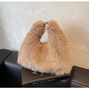 Close-up of fluffy brown faux fur hobo bag with sleek silver metal clasp on display