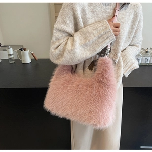 Detail of pink faux fur shoulder bag with soft plush texture and silver metal hardware