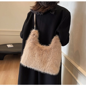 Detail of light brown faux fur hobo bag with long fluffy texture and slim shoulder strap