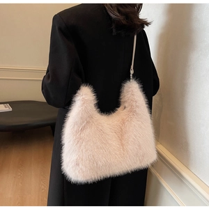 Detail of soft plush pink hobo bag with sleek faux leather strap in a minimalist style