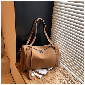 Close-up of vintage brown leather Boston bag with silver zipper and padlock detail