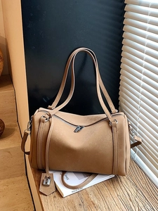 Retro camel suede tote bag with dual zippers and silver padlock detail in natural light