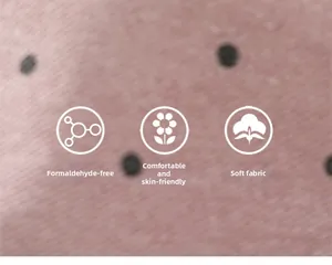 Detail of pink polka dot cotton fabric showing soft texture and skin-friendly quality