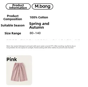 Detail view of 100% cotton pink polka dot straight-leg trousers for girls showing fabric specs