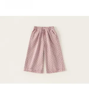 Close-up of pink polka dot pattern children pants with elastic waist and button details
