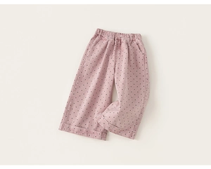 Detailed macro shot of girls pink polka dot wide leg cotton trousers with elastic waist