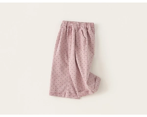 Detail of pink polka dot kids pants featuring elastic waistband and soft cotton fabric
