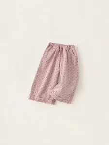 Girl's pink polka dot wide-leg trousers with elastic waist and stylish cuffed hems