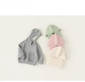 Detailed flat lay of children hooded sweatshirts in grey, green, pink and beige cotton fabric