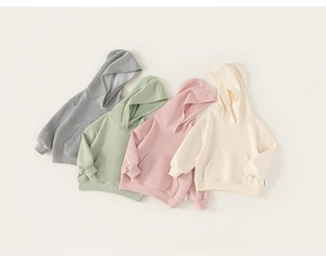 Flat lay of colorful cotton kids hoodies with kangaroo pockets and ribbed cuffs
