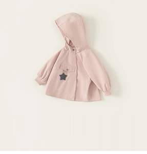 Detail view of pink hooded kids jacket featuring a star charm and ribbed cuffs