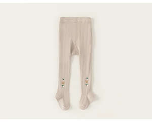 Detail of baby ribbed leggings in beige featuring a cute bear embroidery with green bow
