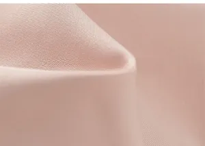 Close-up detail of soft pink woven fabric texture for kids hooded windbreaker coat