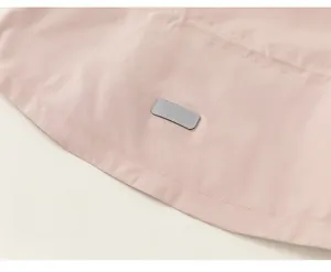 Detail of pink toddler windbreaker showing precise stitching and grey decorative patch
