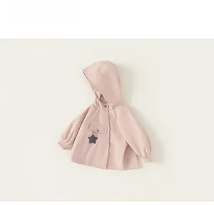 Detail of pink hooded windbreaker for girls with star pendant and front flap pocket