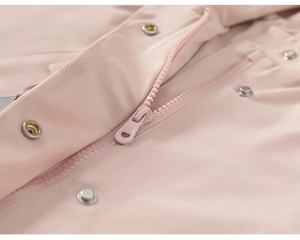 Close-up of smooth resin zipper and silver metal buttons on pink girls hooded jacket