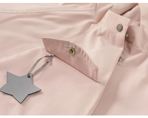 Detail of pink girls windbreaker showing metal snap pocket and star charm accessory