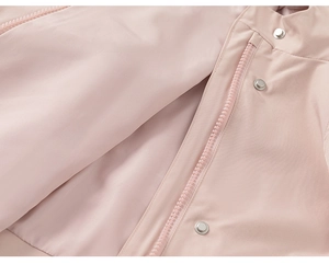Detailed macro view of the light pink kids windbreaker with zipper and metal snap buttons