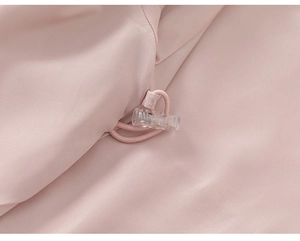Detail of pink functional jacket showing adjustable drawstring and clear cord lock toggle
