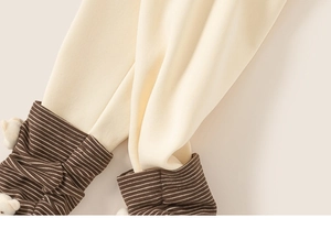 Detail of ribbed striped cuffs and 3D bear ornament on children's fleece warm trousers