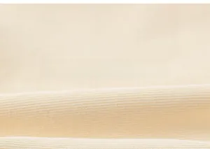 Macro shot of cream ribbed knit fabric texture for kids leggings with soft elastic feel
