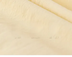 Close-up of skin-friendly beige fabric with soft crinkled texture and eco-friendly material