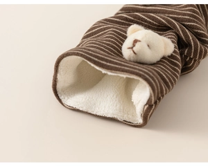 Detailed view of striped baby leggings with fleece lining and cute 3D teddy bear patch