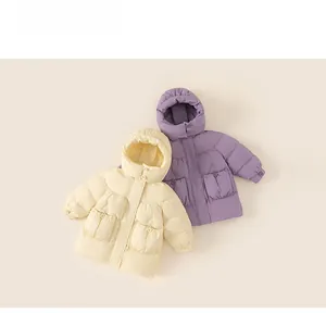Flat lay of girl's quilted puffer jacket with hood and large flap pockets in beige