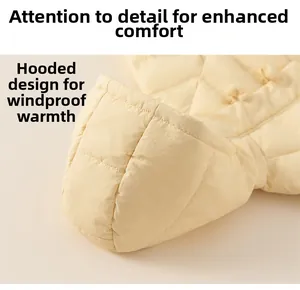 Close-up of windproof hooded design on light yellow quilted winter down jacket for girls