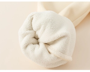 Close-up of winter fleece lining on kids' thick warm trousers with neat inner stitching