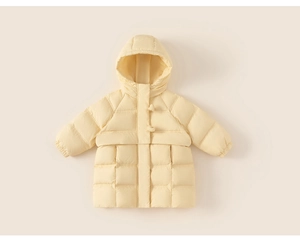 Detail of hooded kids puffer jacket featuring toggles and quilted cream fabric
