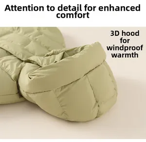 Detail view of water-resistant green down jacket with windproof hooded collar design