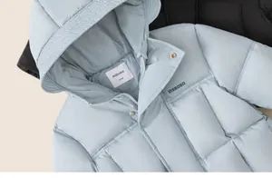 Detail view of children's hooded down jackets with matte finish and quilted texture